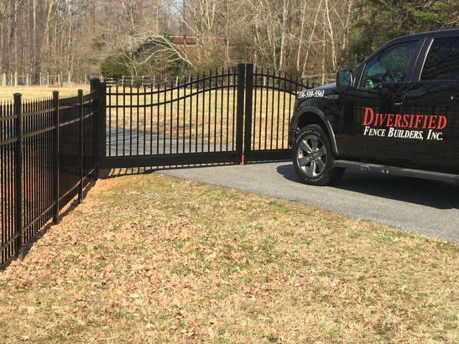 black fence with gate and company truck