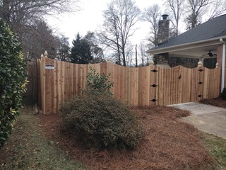 house with wooden fence and landscaping