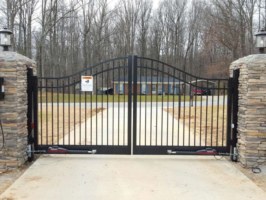 driveway gate with stone pillars